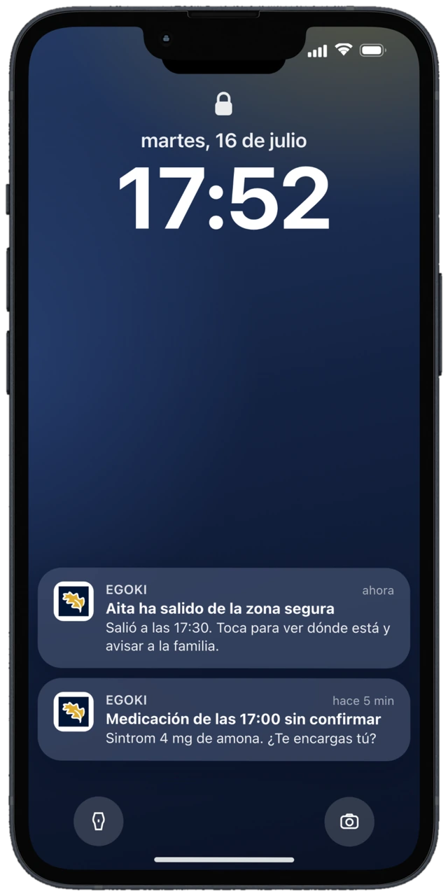 Pantalla de bloqueo de un iPhone con dos avisos de Egoki: una salida de la zona segura y una medicación sin confirmar